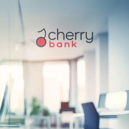 Cherry Bank logo on a glass wall in a bright, modern office setting.